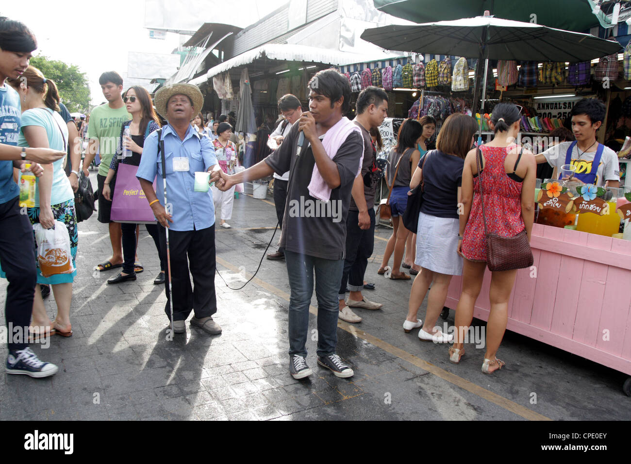 Blind singer on street at Chatuchak Weekend Market in Bangkok Stock