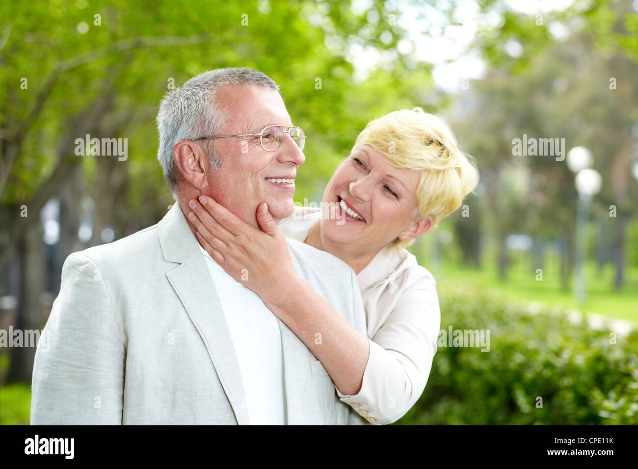 Portrait of happy mature woman looking at her husband outside Stock Photo