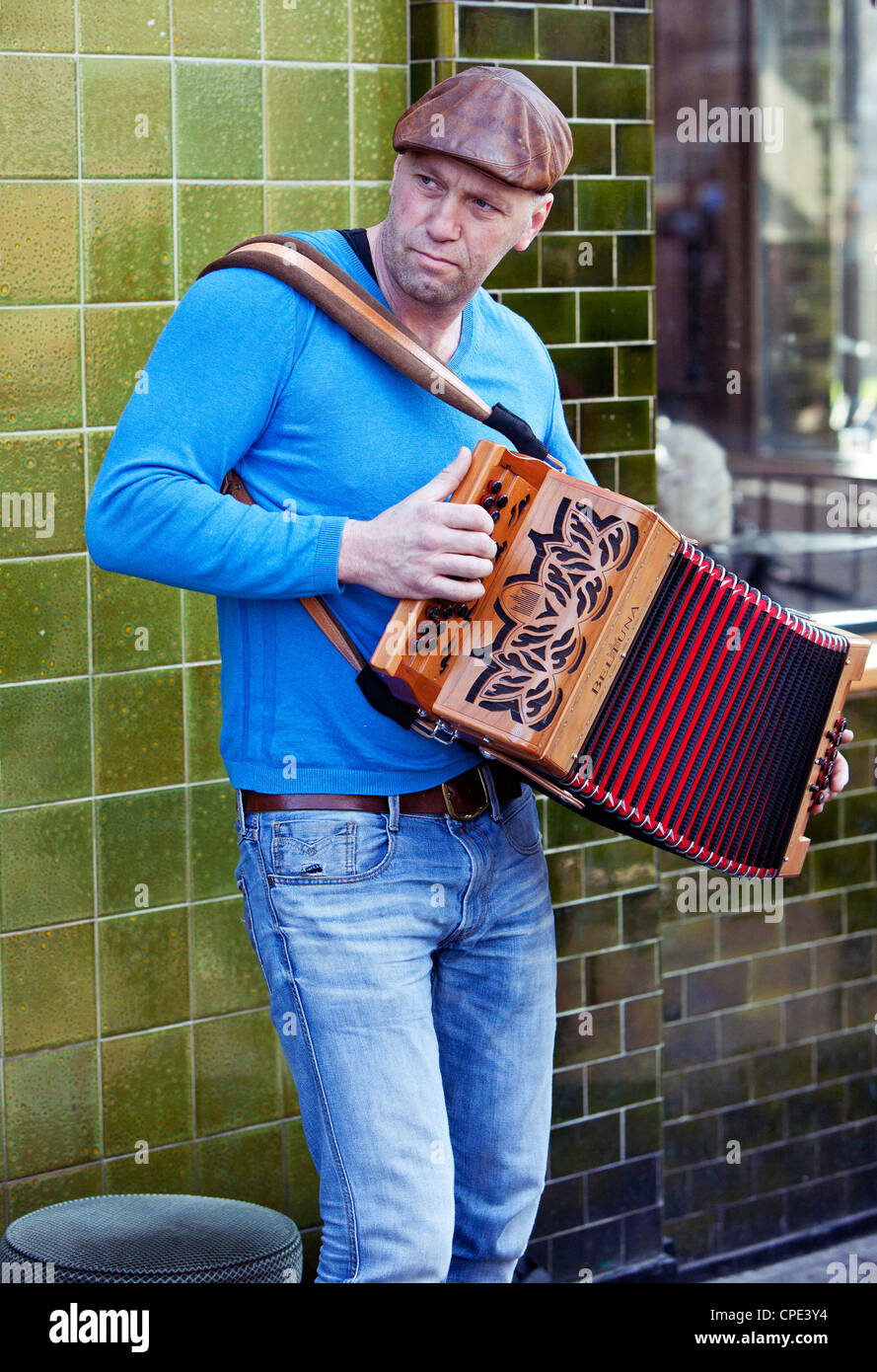 Portrait of a busker playing an accordion, Columbia Road Flower Market, London, England, UK Stock Photo