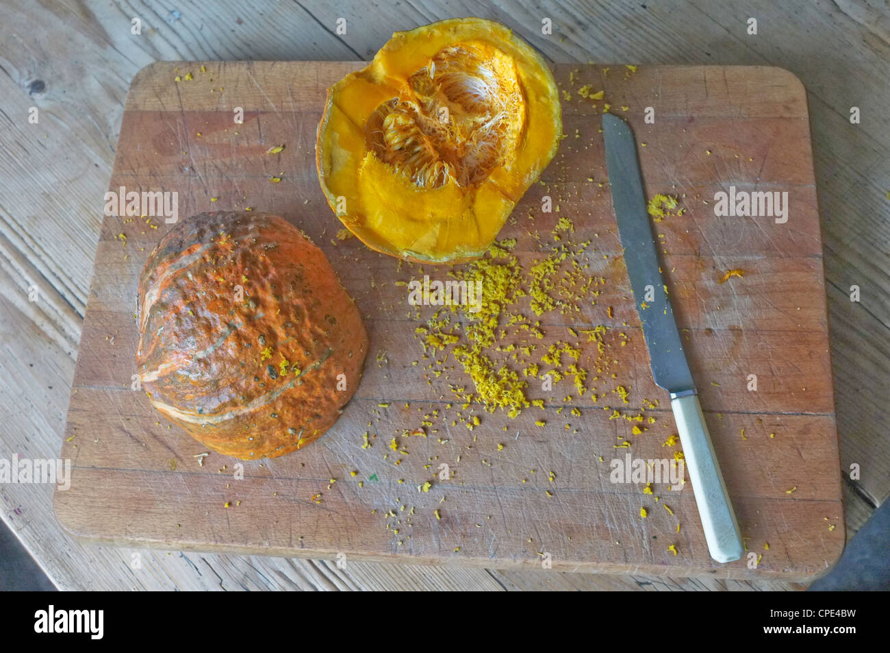 A freshly cut pumpkin on a bread board Stock Photo
