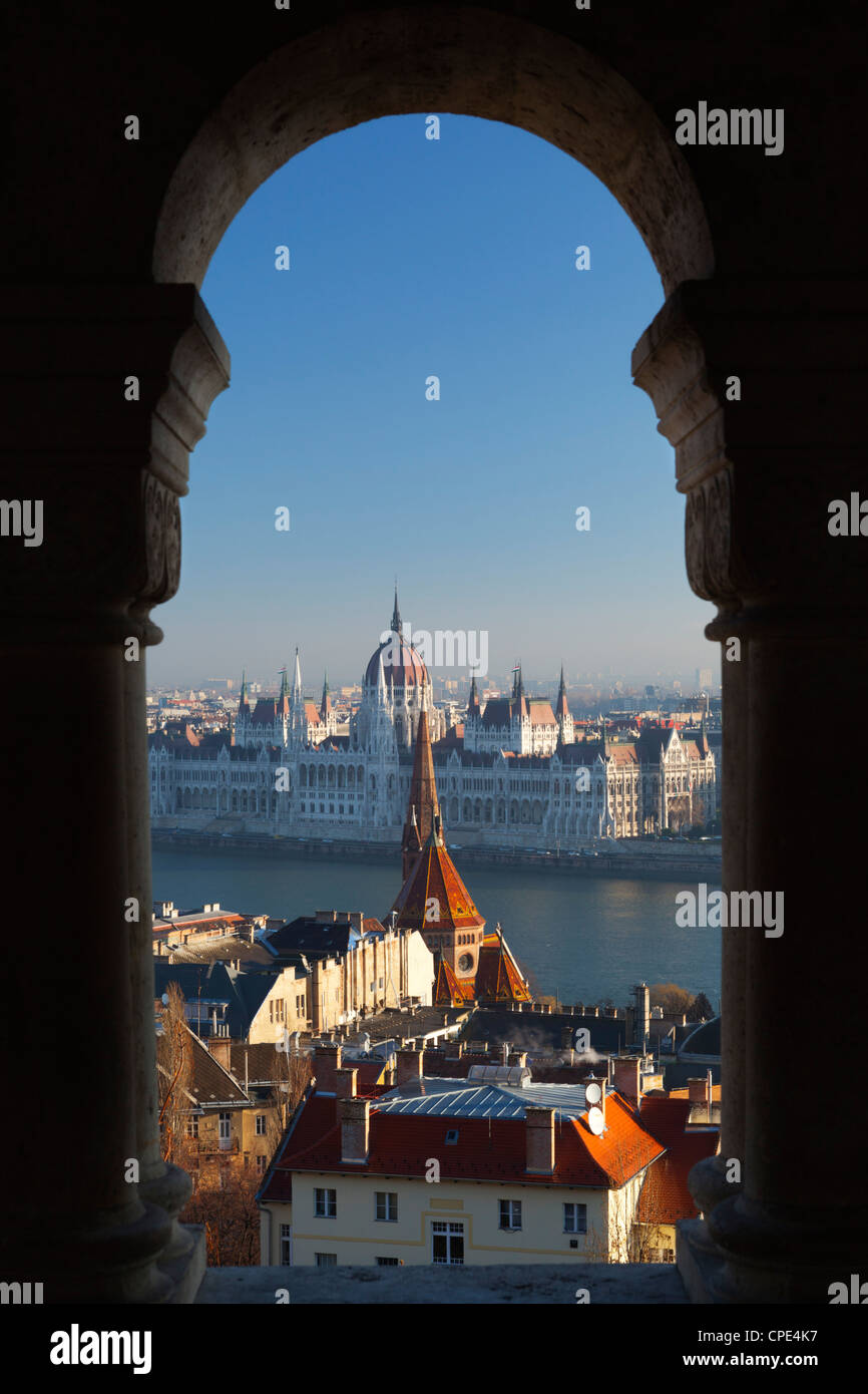 Parliament (Orszaghaz) and River Danube through arches of Fishermen's Bastion (Halaszbastya), Buda, Budapest, Hungary, Europe Stock Photo