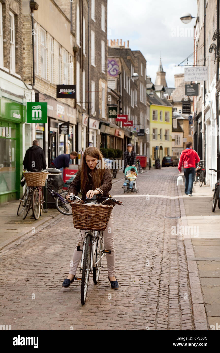 A young woman on her bicycle, Green Street Cambridge UK Stock Photo