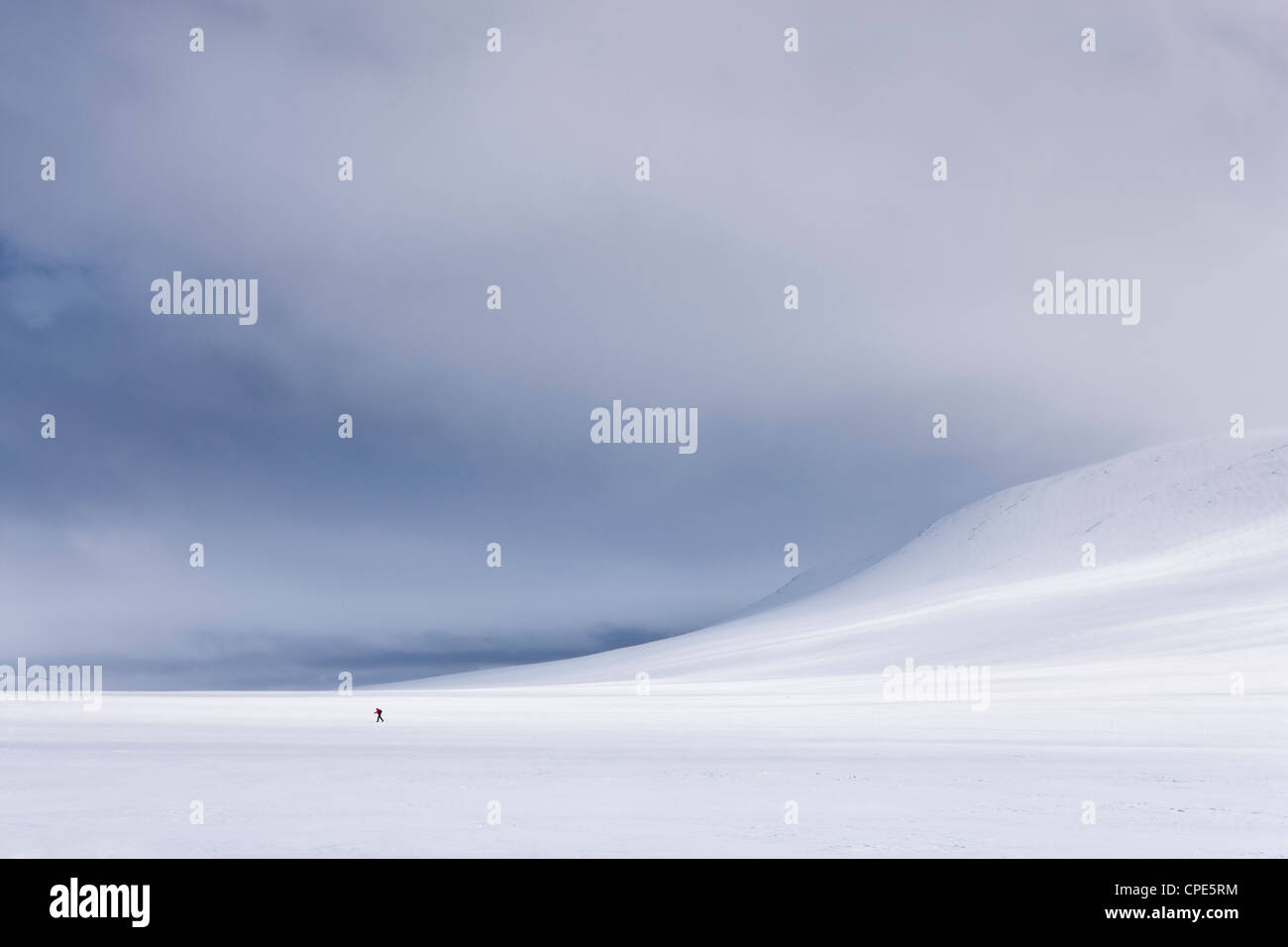 Lone figure skis across Rondane National Park, Norway, Scandinavia, Europe Stock Photo