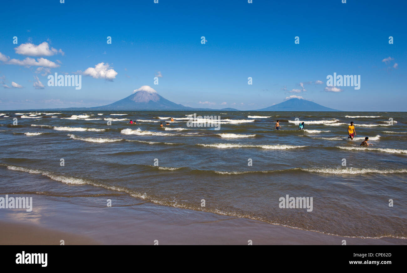 Ometepe Island and swimmers in Lake Nicaragua, Nicaragua, Central America Stock Photo