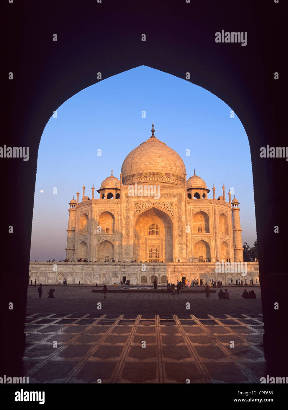 The Taj Mahal just before sunset framed by the mosque arch and ...