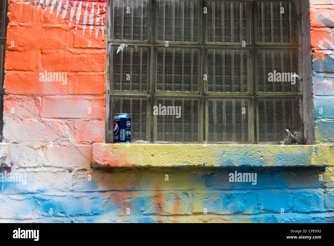 An empty Pepsi Cola drink can with the 'Transform Your Patch' promotion logo left on an street art decorated window sill. Stock Photo
