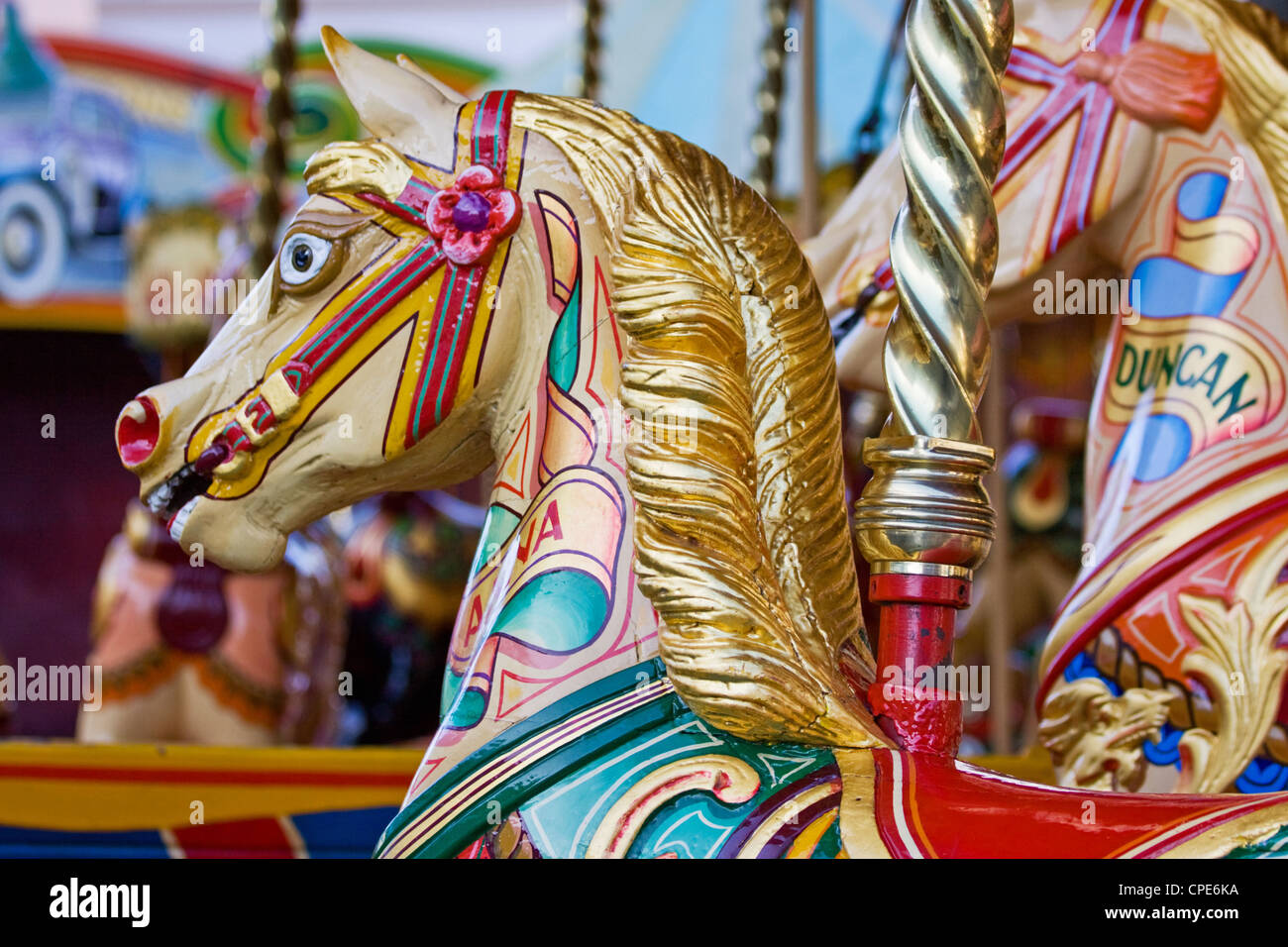 Children's horse rides on a traditional steam fairground merry-go-round UK Stock Photo