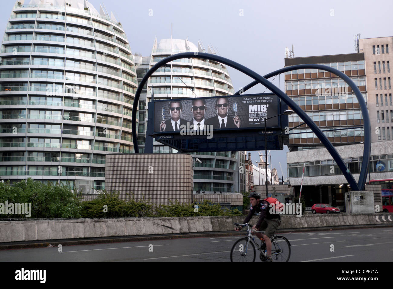 Cycylist and billboard advert for movie cinema film MIB 'Men In Black' Old Street Silicon Roundabout in London UK KATHY DEWITT Stock Photo