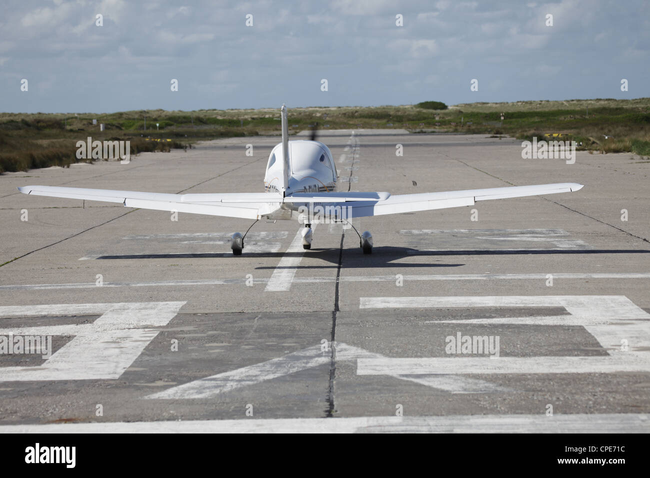 Private small airplane ready for take-off on the runway of a small island, Helgoland, North Sea Stock Photo