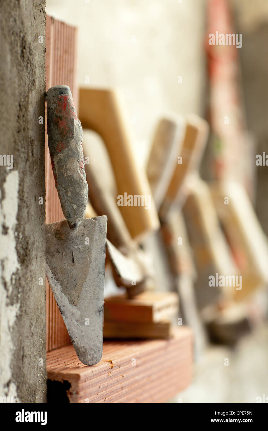 Construction mason cement mortar tools in a row Stock Photo - Alamy