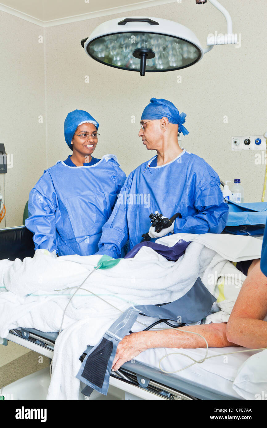Surgery with operating table, nurse and surgeon Stock Photo - Alamy