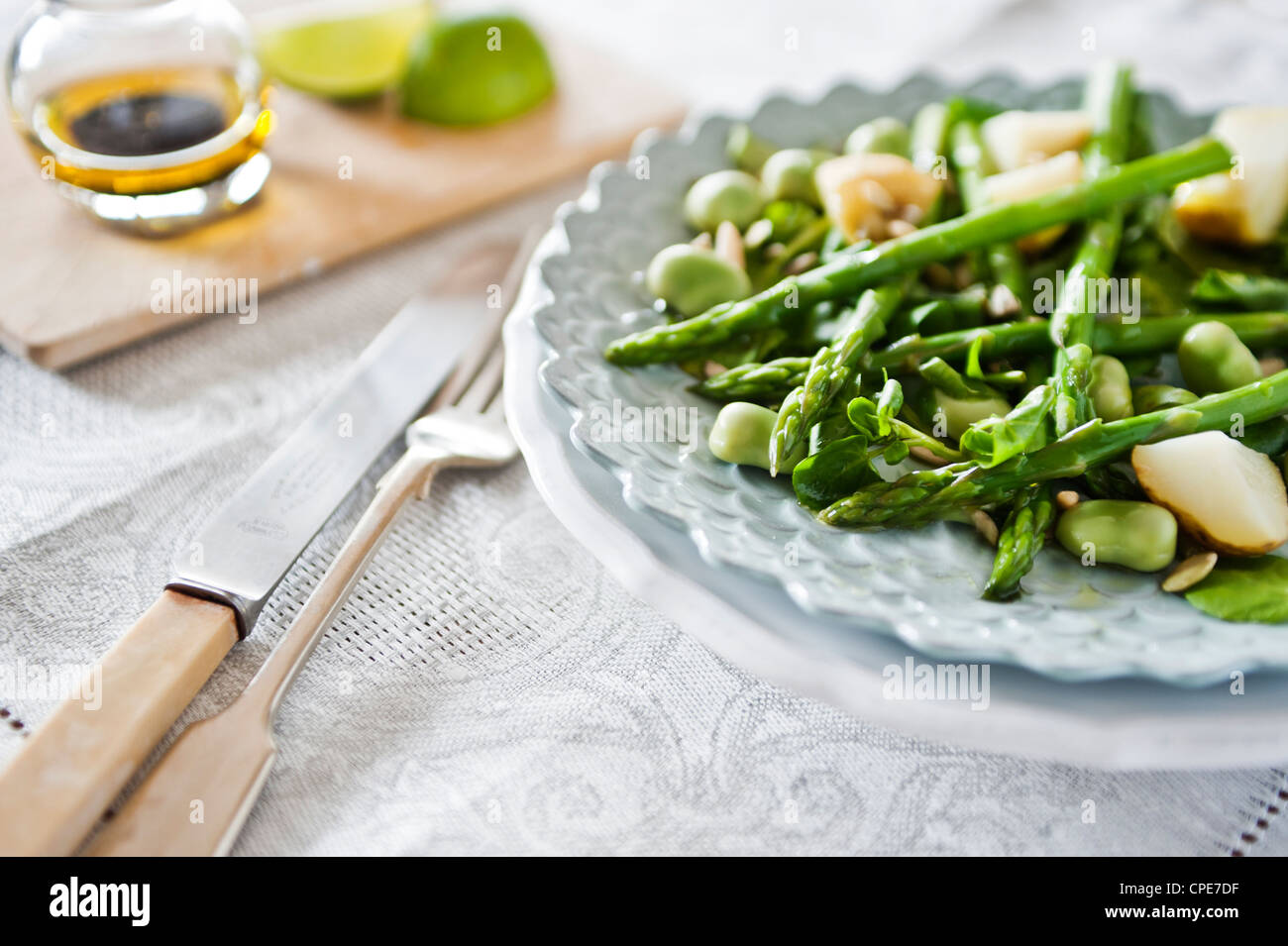 Food still life of asparagus, broad bean, new potato and mint salad Stock Photo