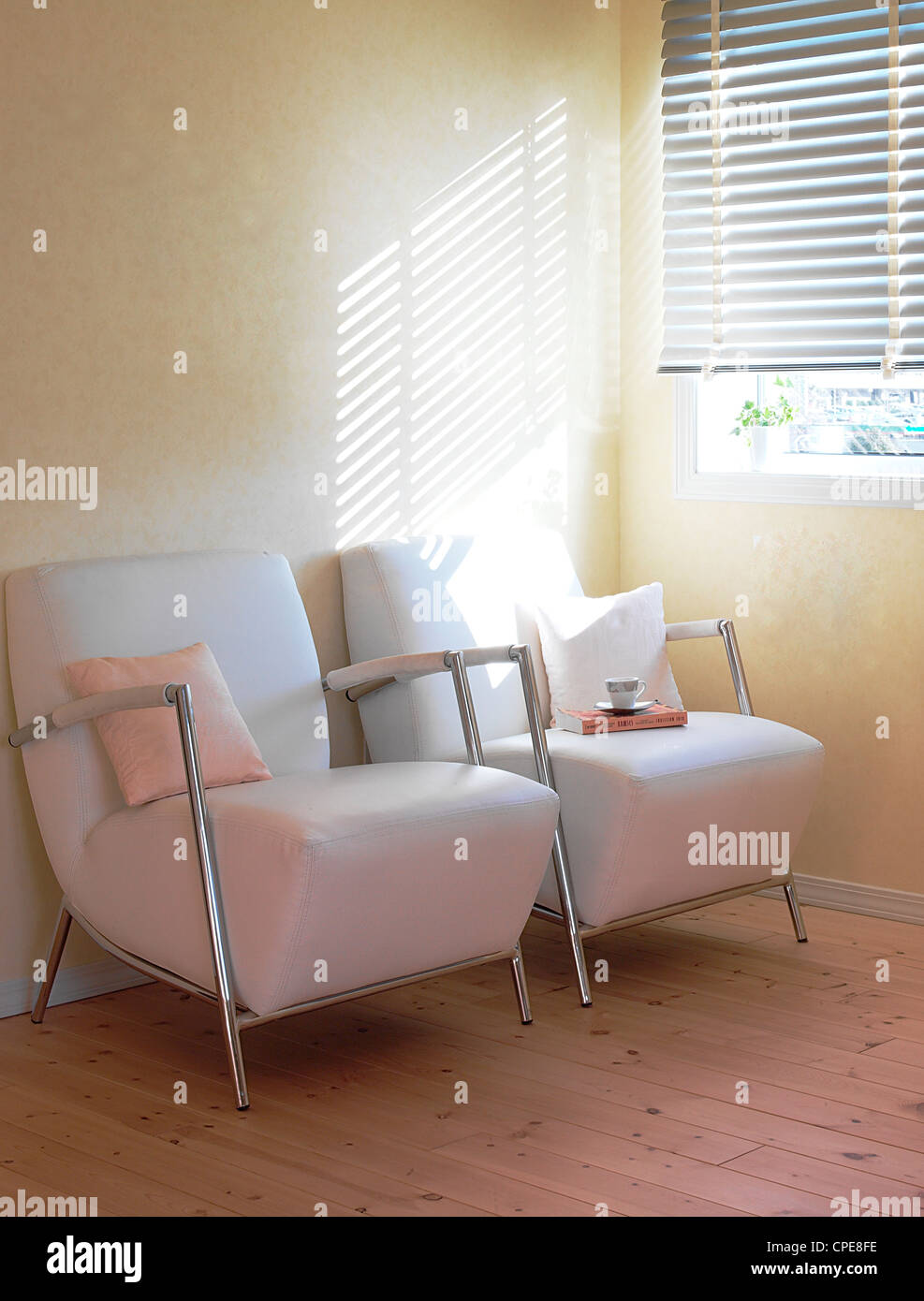 Easy Chairs With Sunlight Coming From Window Blinds Stock Photo