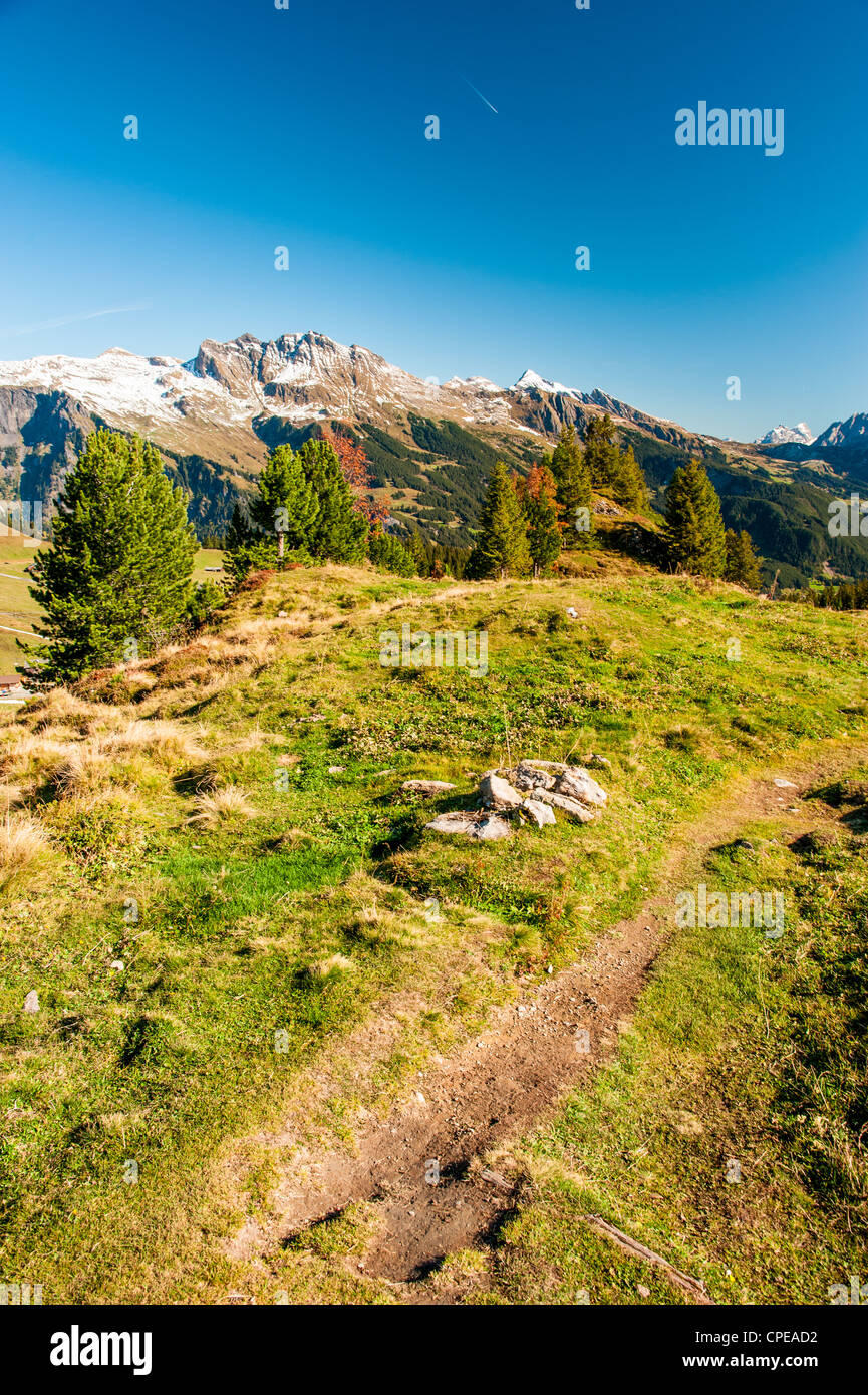 Hiking trail in swiss alps at Maennlichen above Grindelwald, Switzerland Stock Photo
