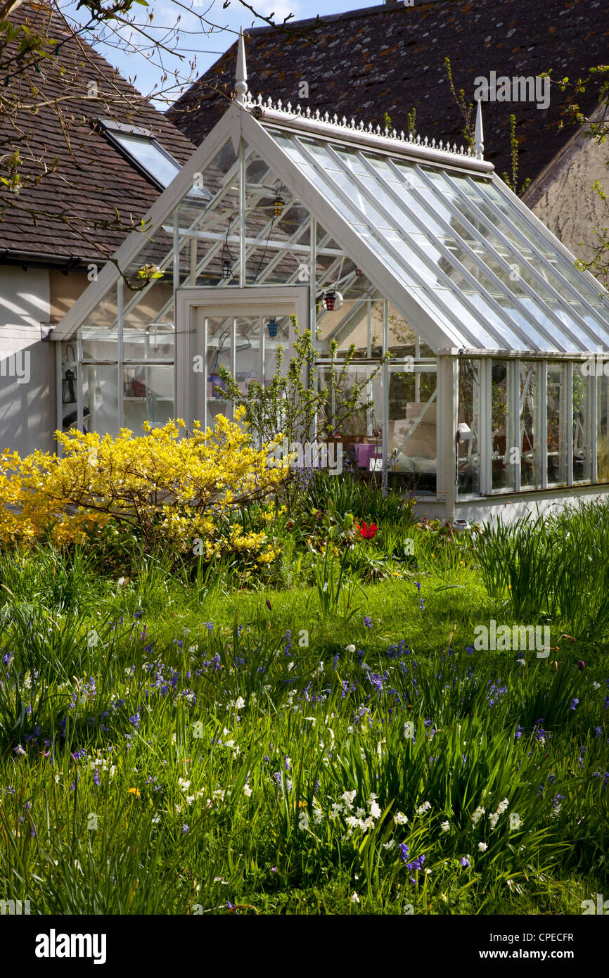 Traditionally made old style Victorian glass greenhouse in private garden Stock Photo