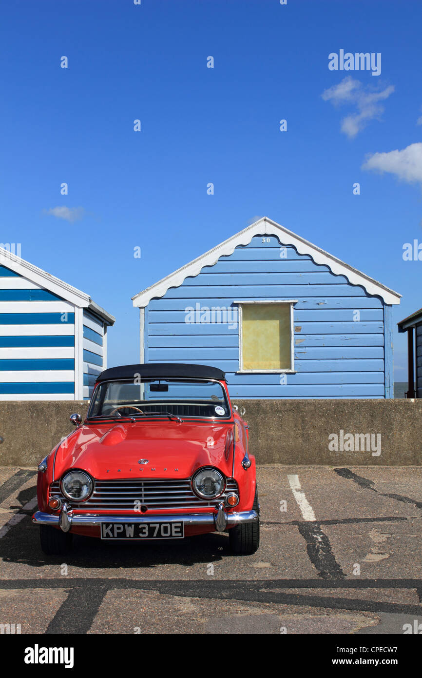 Colourful beach huts and Triumph TR4 at the famous coastal resort of Southwold Suffolk England UK Stock Photo