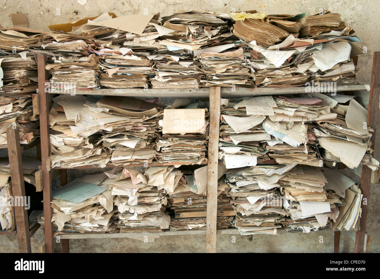 Rickety wooden shelves filled with old documents. Stock Photo