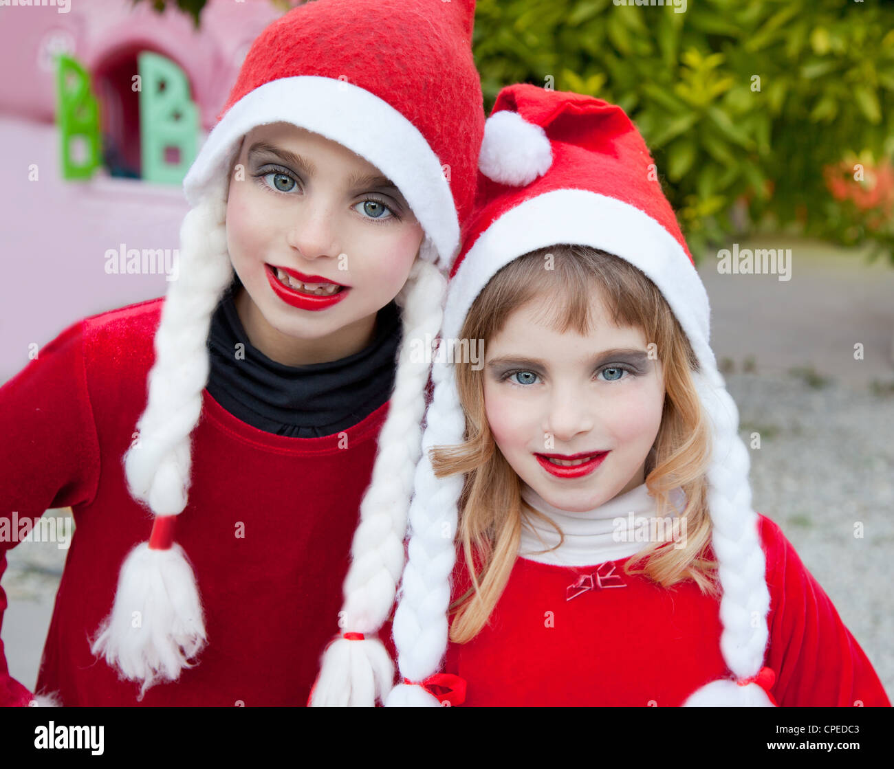 Christmas santa costumer kid girls makeup portrait smiling outdoor Stock Photo