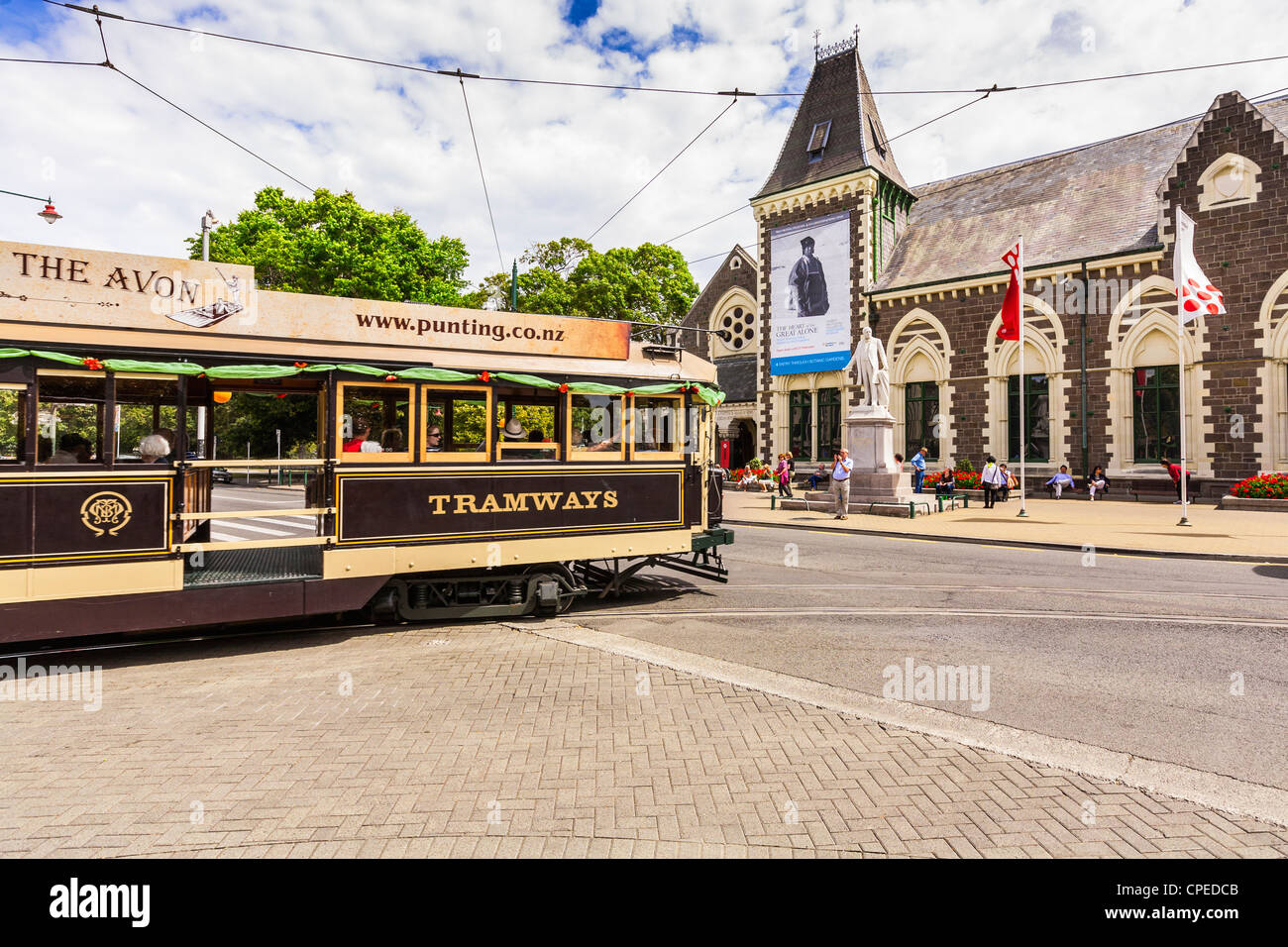 A restored tram turns from Worcester Boulevard into Rolleston Avenue, past the Canterbury Museum in Christchurch, New Zealand. Stock Photo