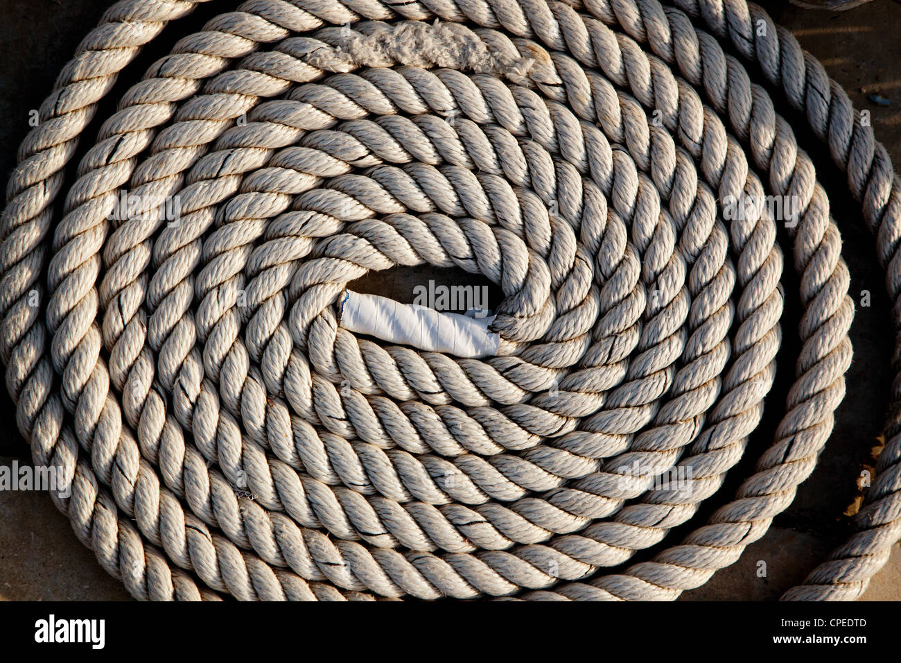 coil of marine rope detail in marina port Stock Photo