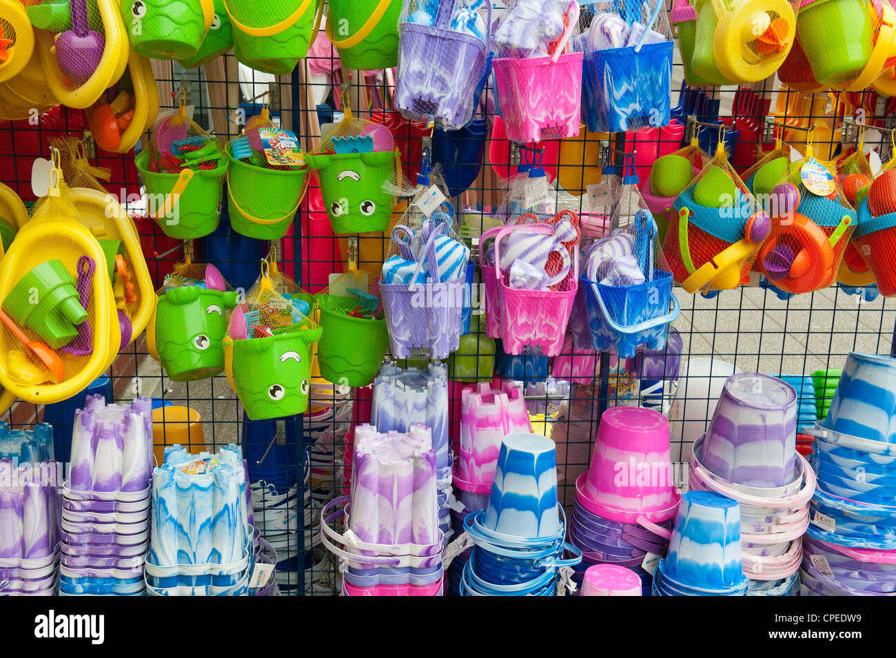 Colourful beach sandcastle buckets and spades for sale in a Devon town Stock Photo