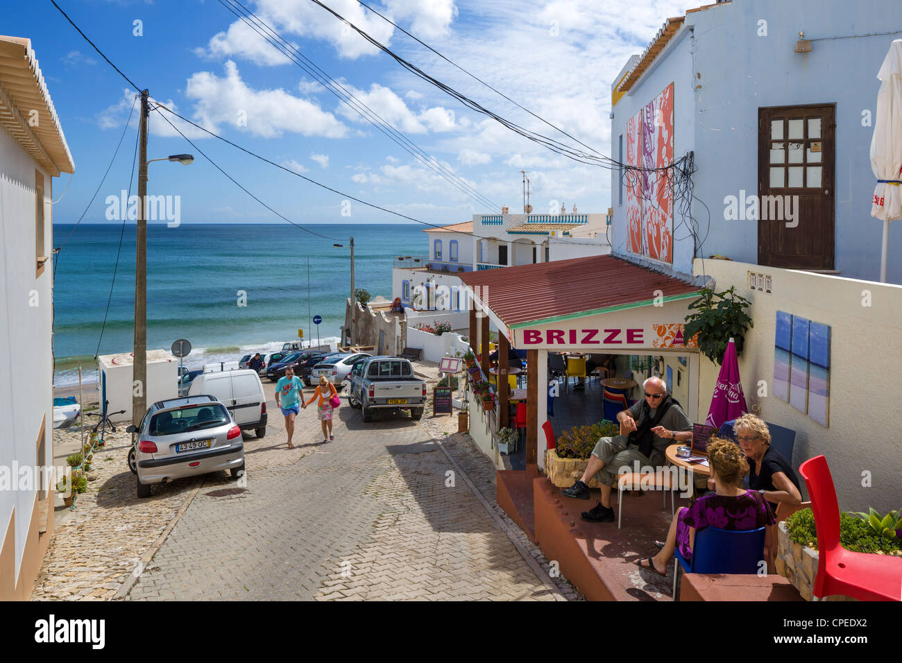 Terrace of cafe overlooking beach in small fishing village of Brugau on the coast between Sagres and Lagos, Algarve, Portugal Stock Photo