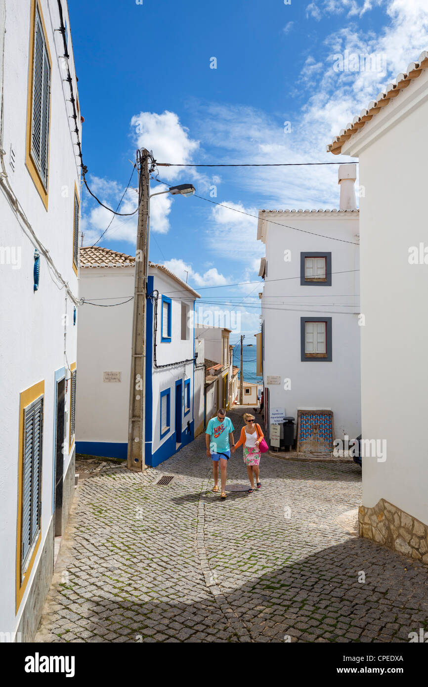 Street in the small fishing village of Burgau on the coast between Sagres and Lagos, Algarve, Portugal Stock Photo