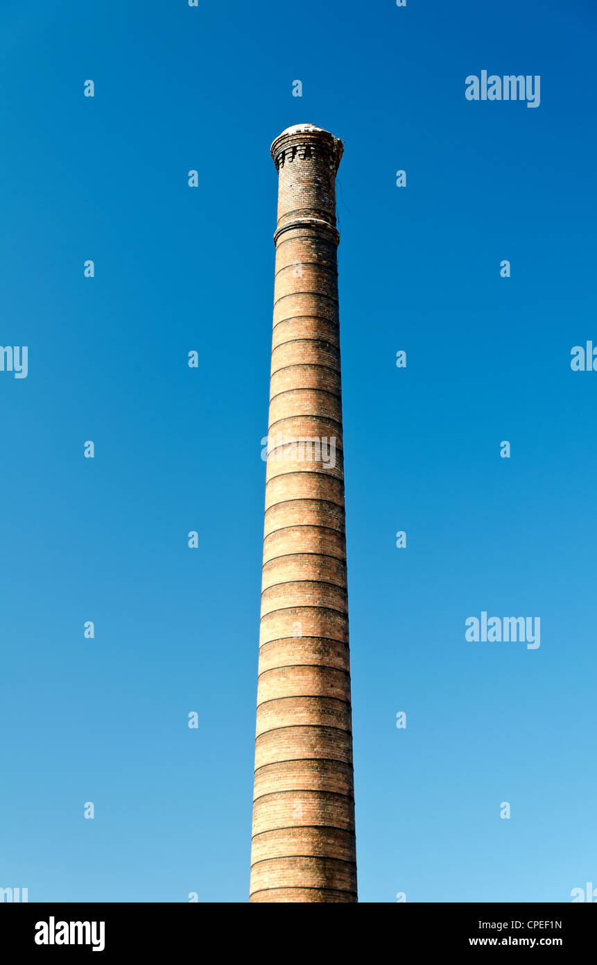 Industrial brick chimney against bright blue sky Stock Photo - Alamy