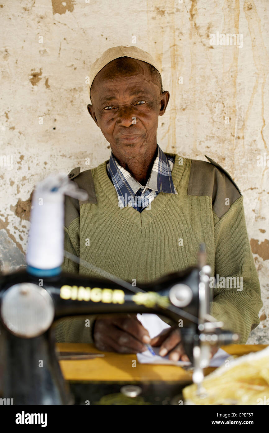 Tailor with sewing machine in Guludo village in the Quirimbas National Park in northern Mozambique. Stock Photo