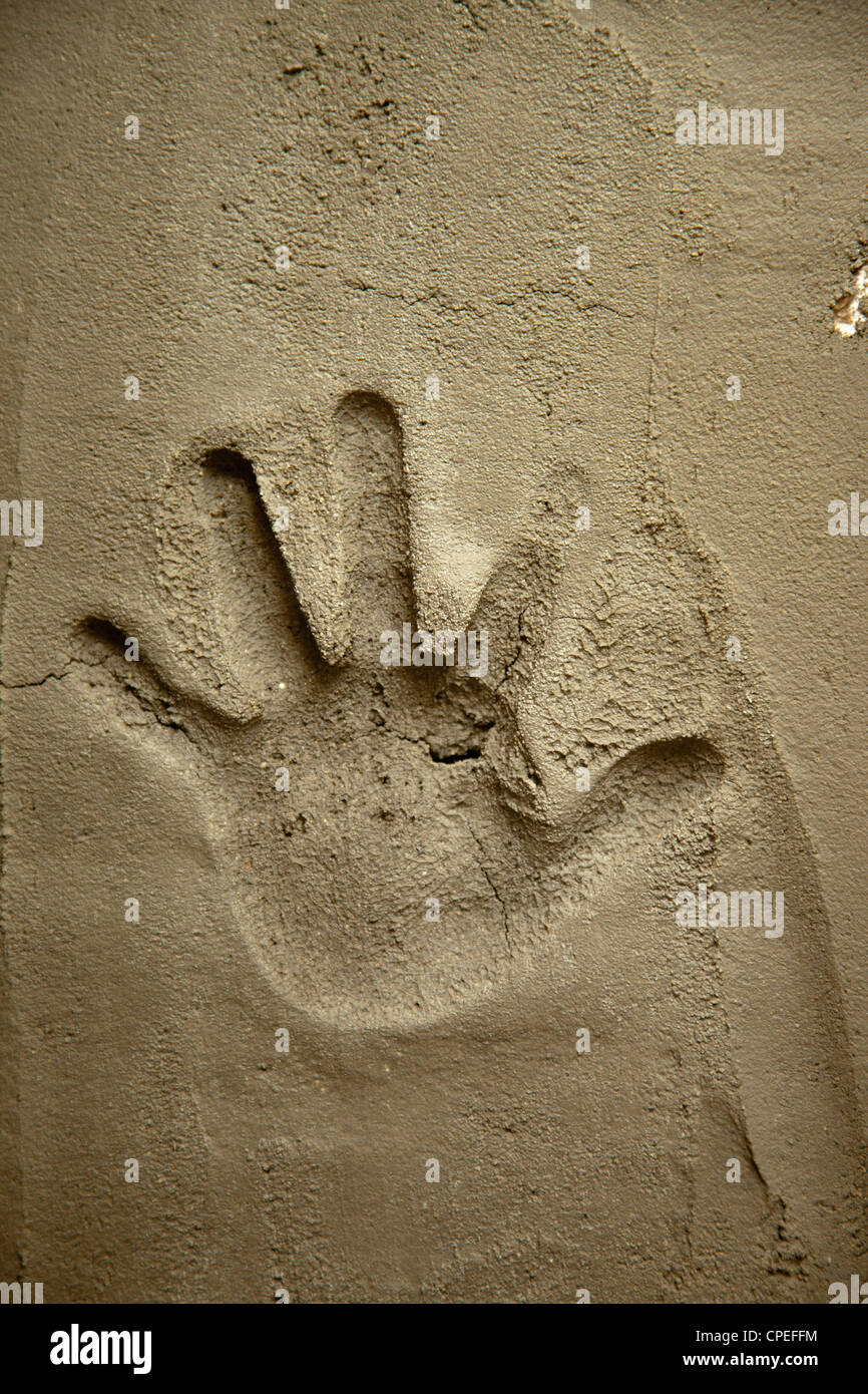 hand print on cement mortar wall with shadow relief Stock Photo