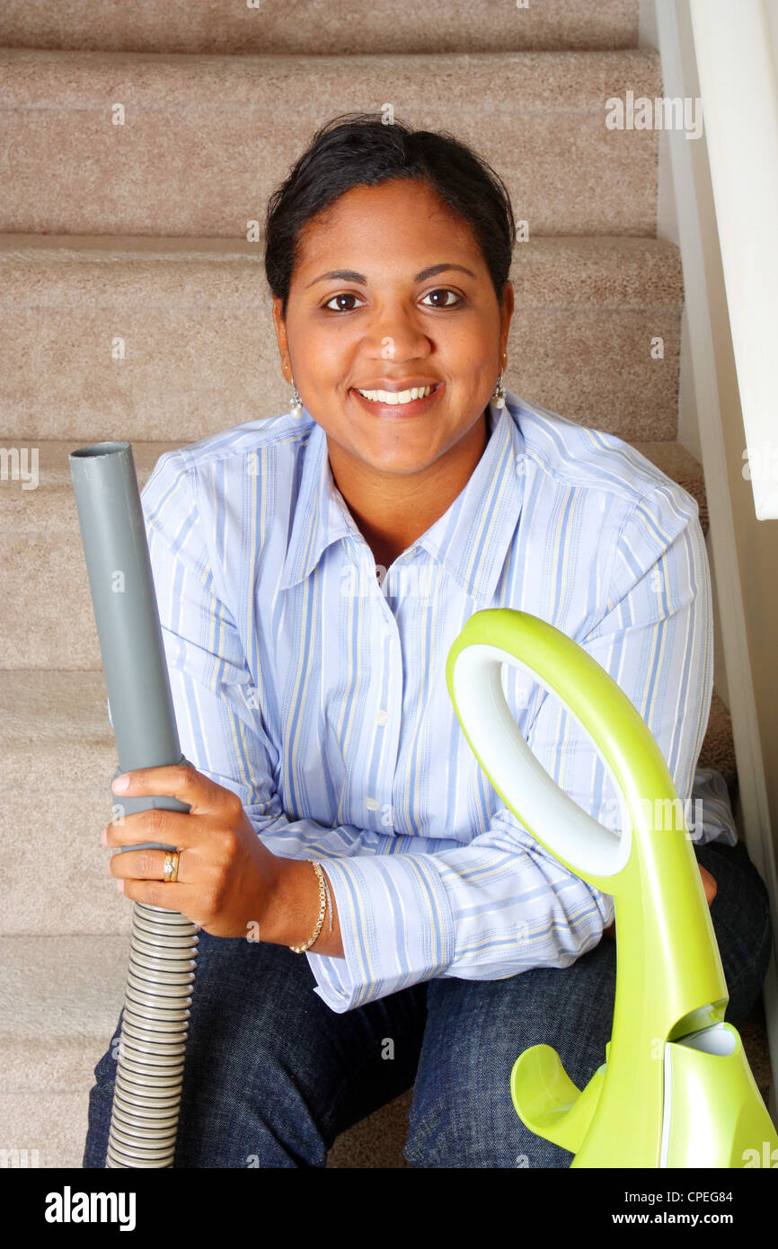 Woman cleaning in her house with a vacuum cleaner Stock Photo Alamy