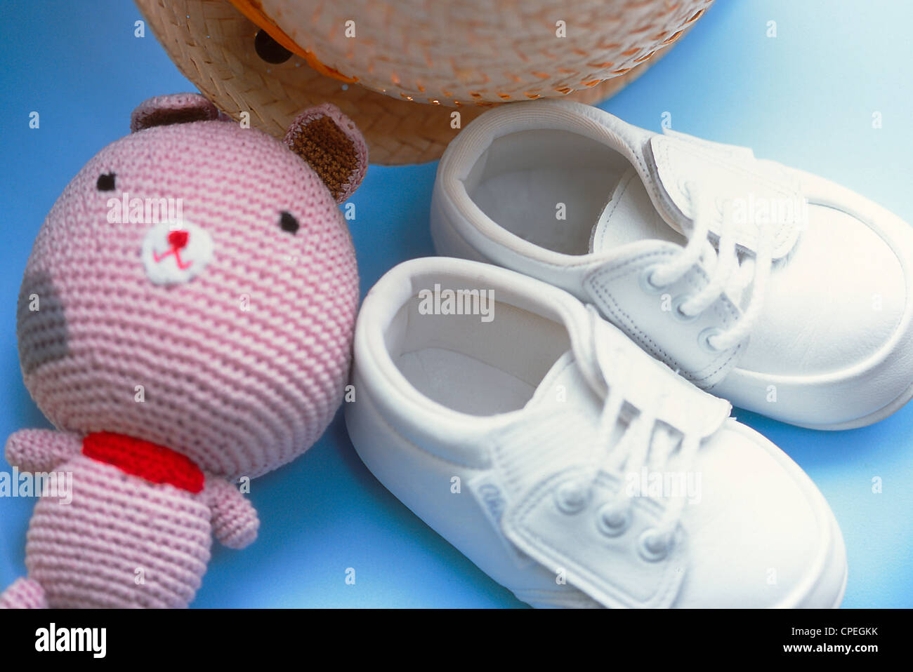 Baby Shoes, Toy And Hat On Chair Stock Photo