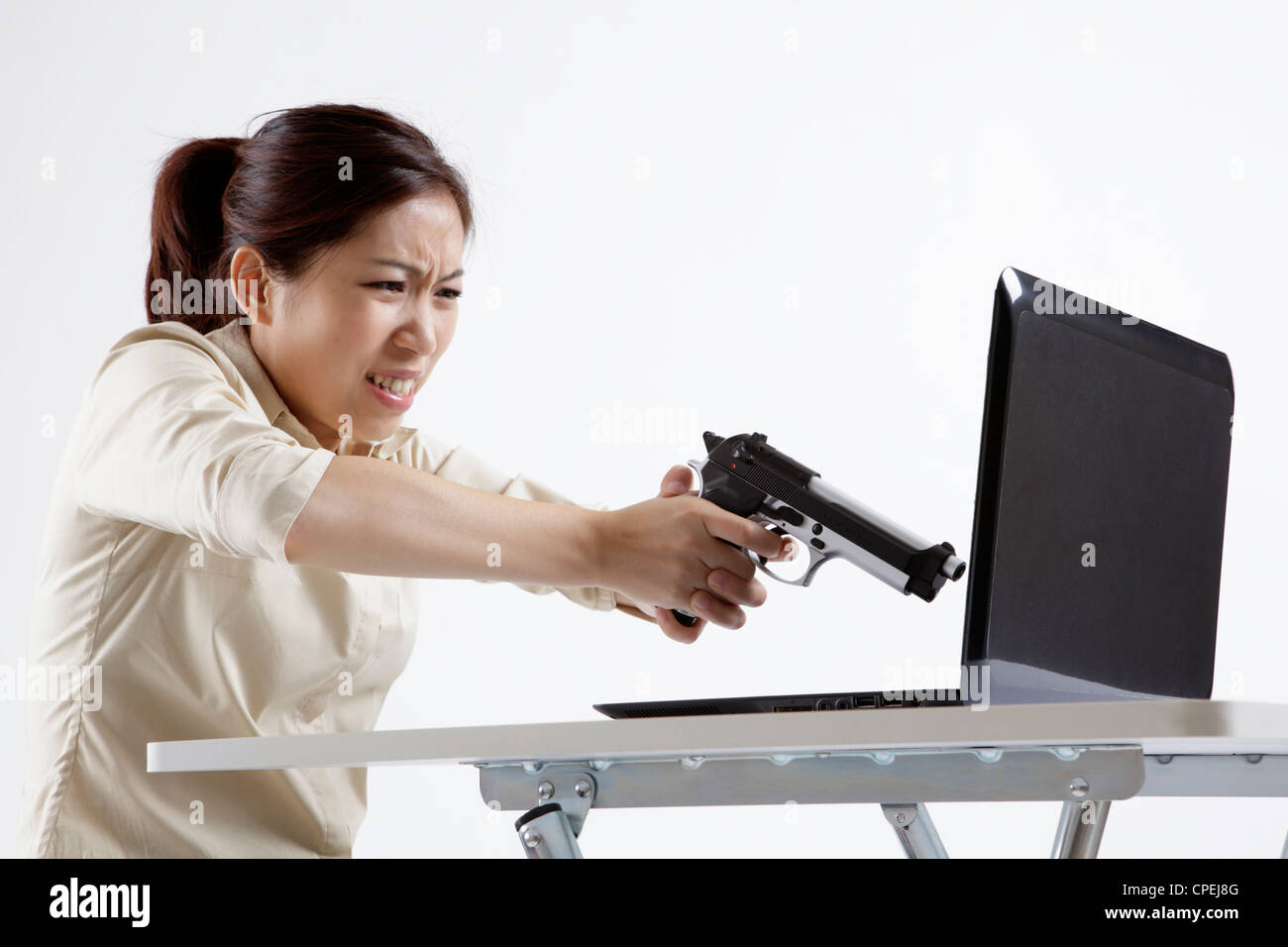Office lady is tired of working and wants to shoot computer Stock Photo ...