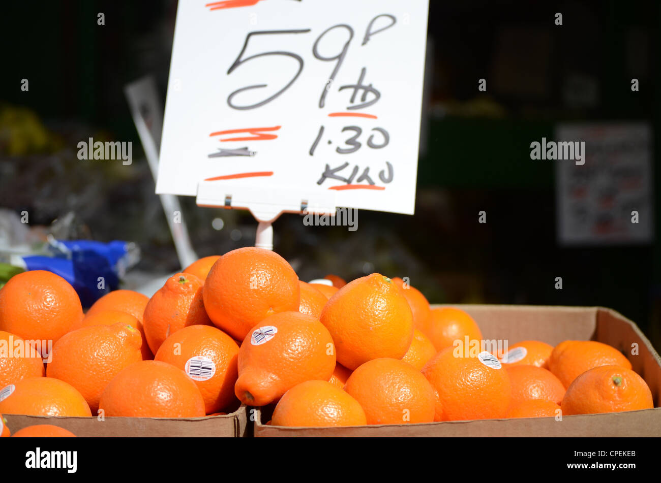A box of oranges with price card Stock Photo Alamy