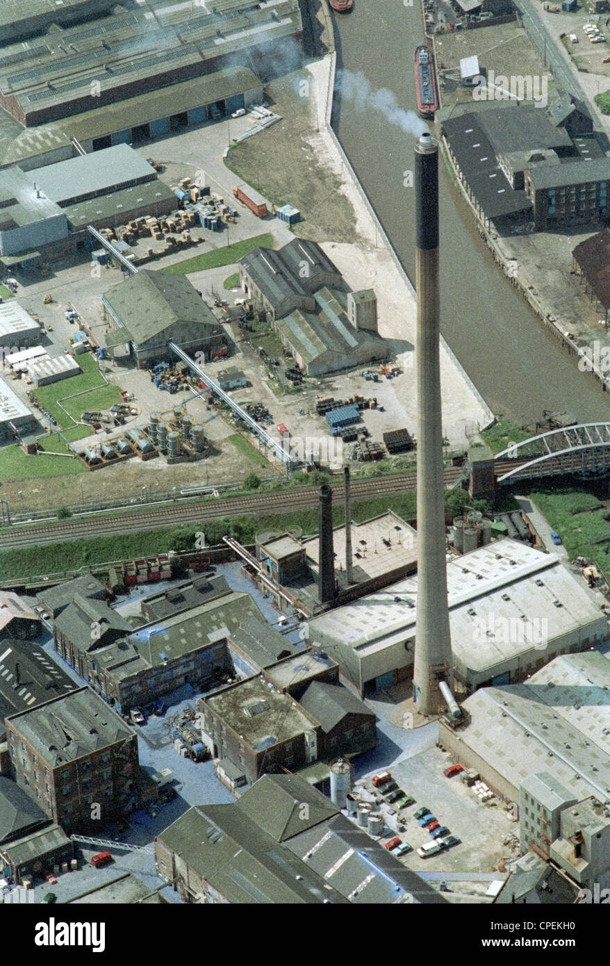 Oblique aerial view of factory chimney in Hull next to the River Hull producing pollution Stock Photo