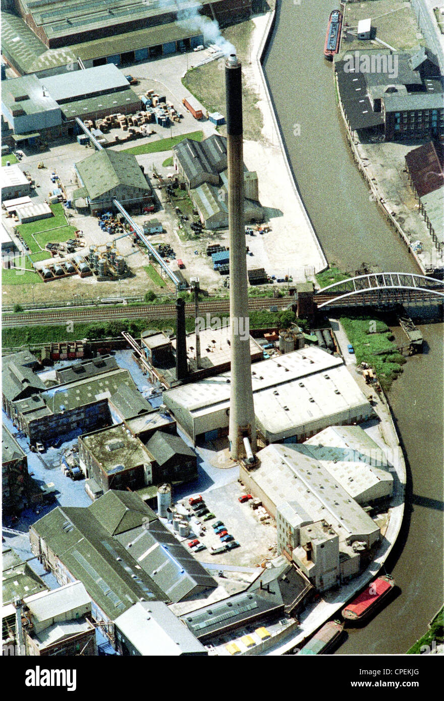Oblique aerial view of factory chimney in Hull next to the River Hull producing pollution Stock Photo