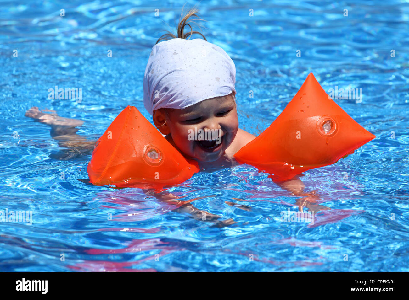 Toddler Girl With Swimmies In Pool Stock Photo Alamy