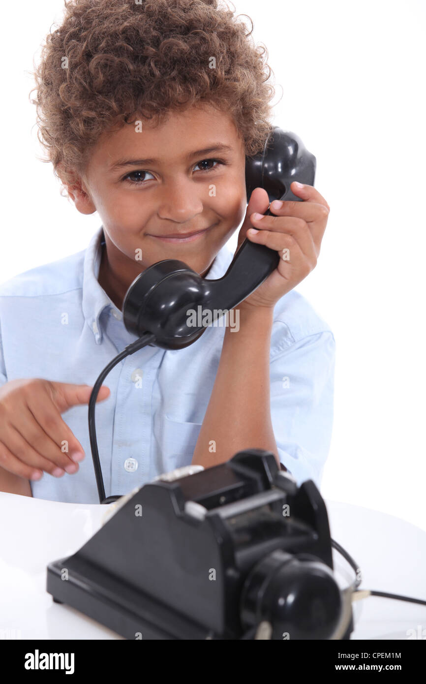 Young boy with an old-fashioned telephone Stock Photo