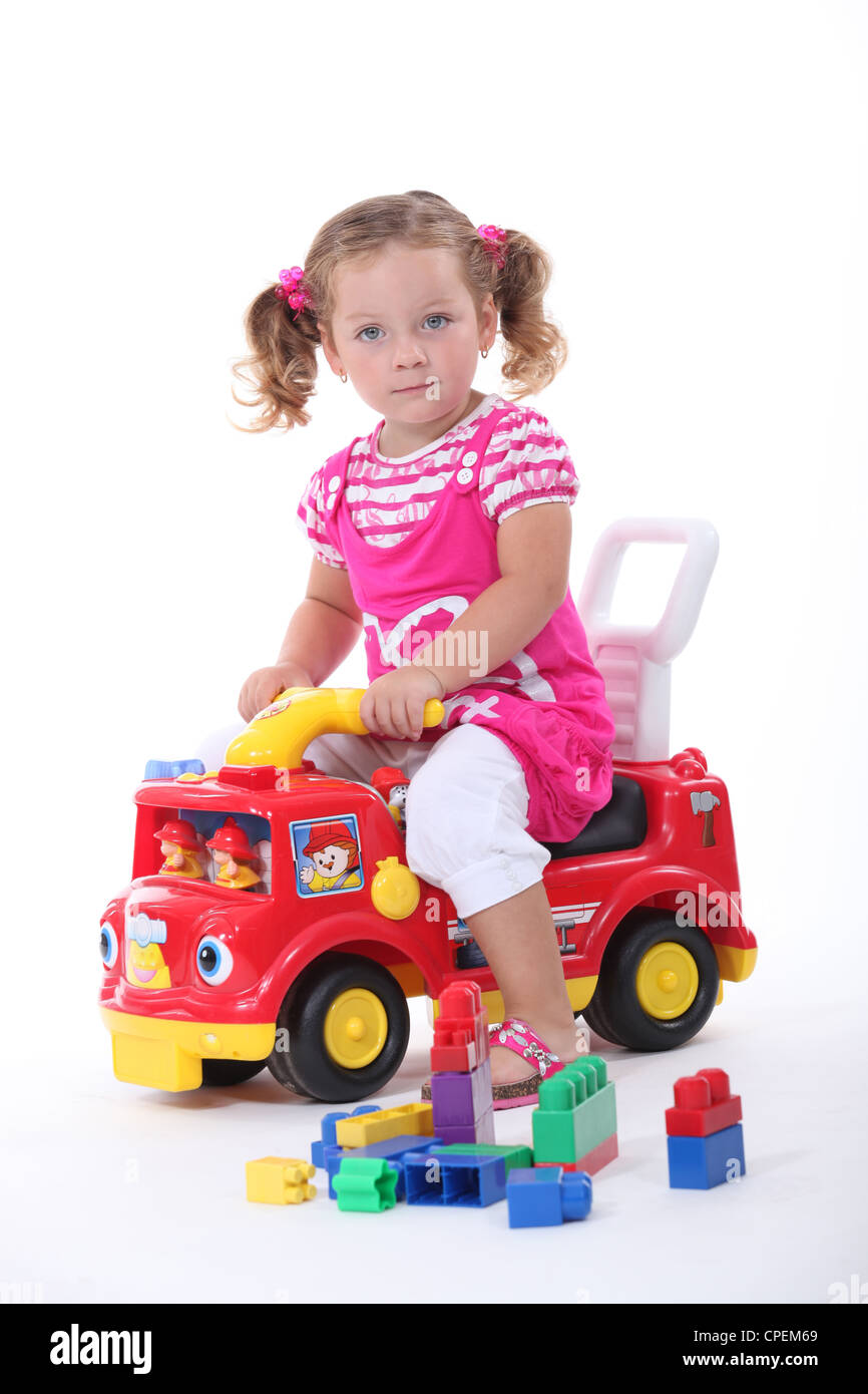 Girl with a toy fire engine Stock Photo