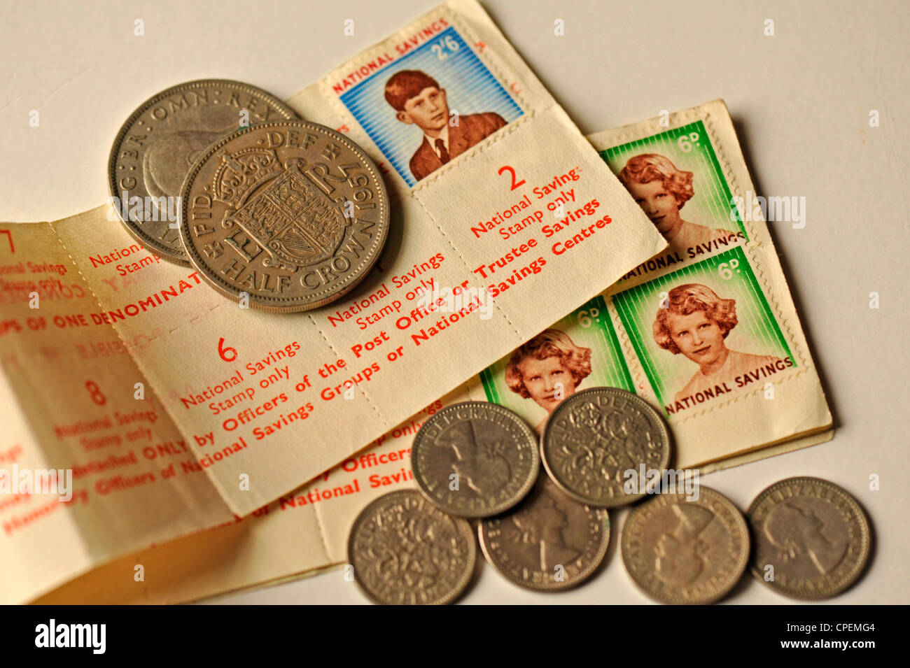 Old coins and National Savings stamps Stock Photo