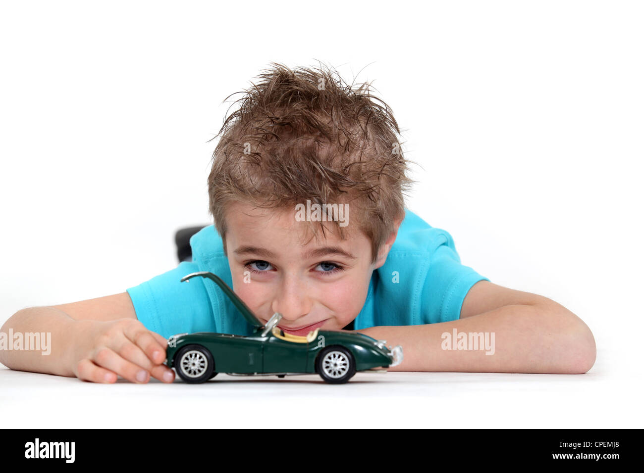Young boy playing with a toy car Stock Photo - Alamy