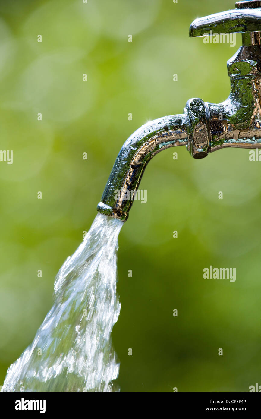 Running Water From Faucet With Blur Background Stock Photo