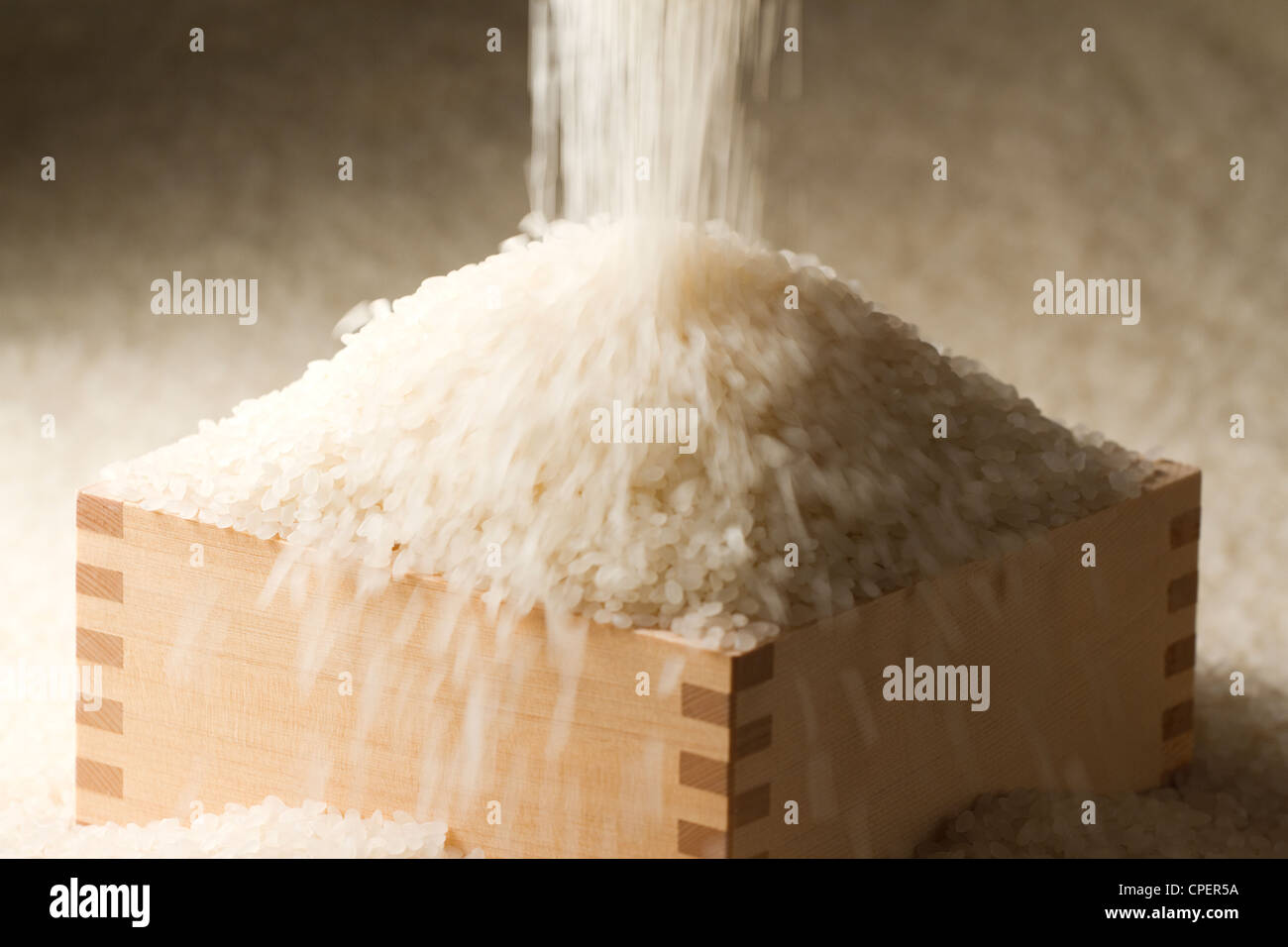 Rice Overflowing From Wooden Box Stock Photo
