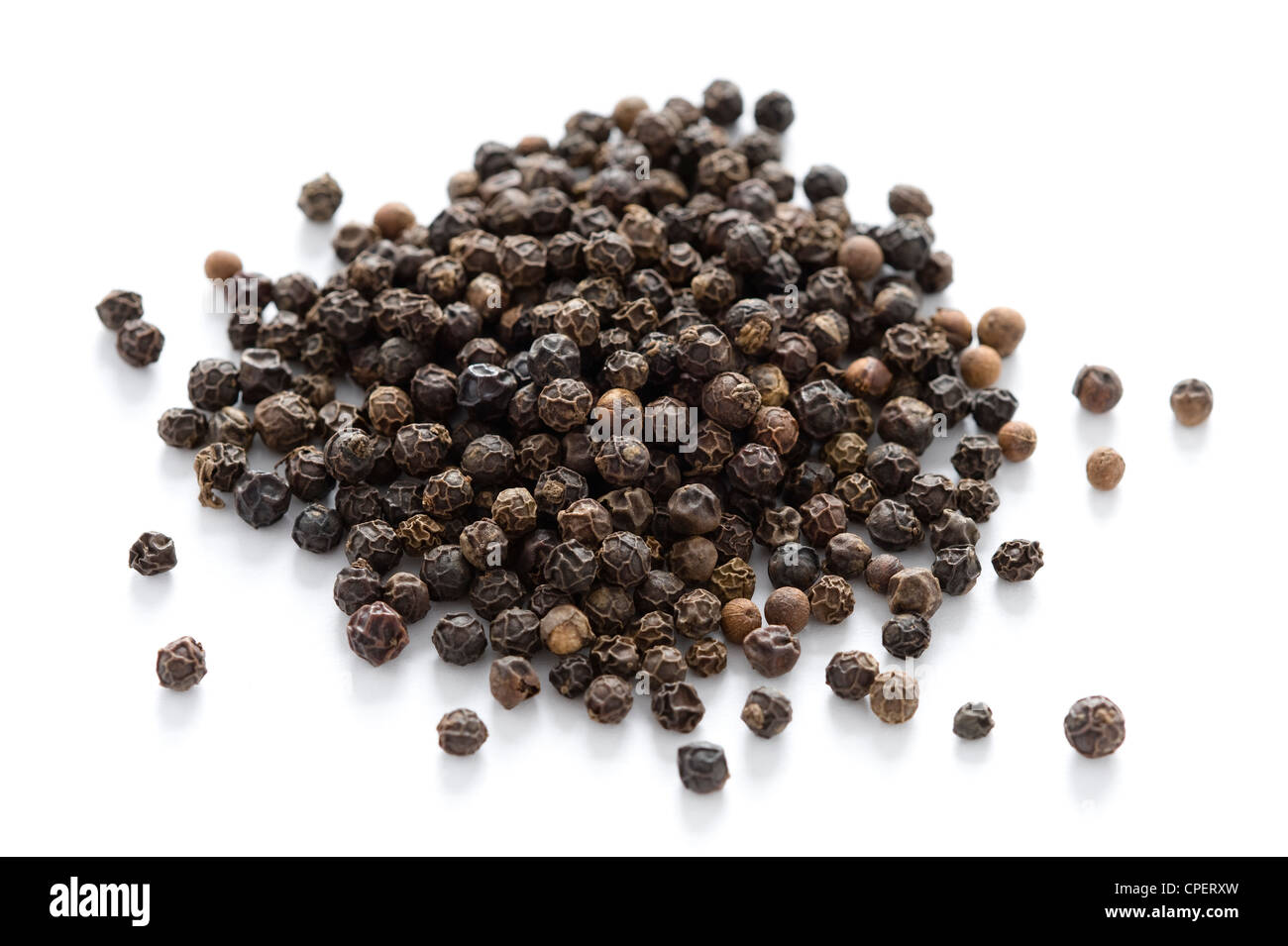 heap of black peppercorns isolated on a white background Stock Photo