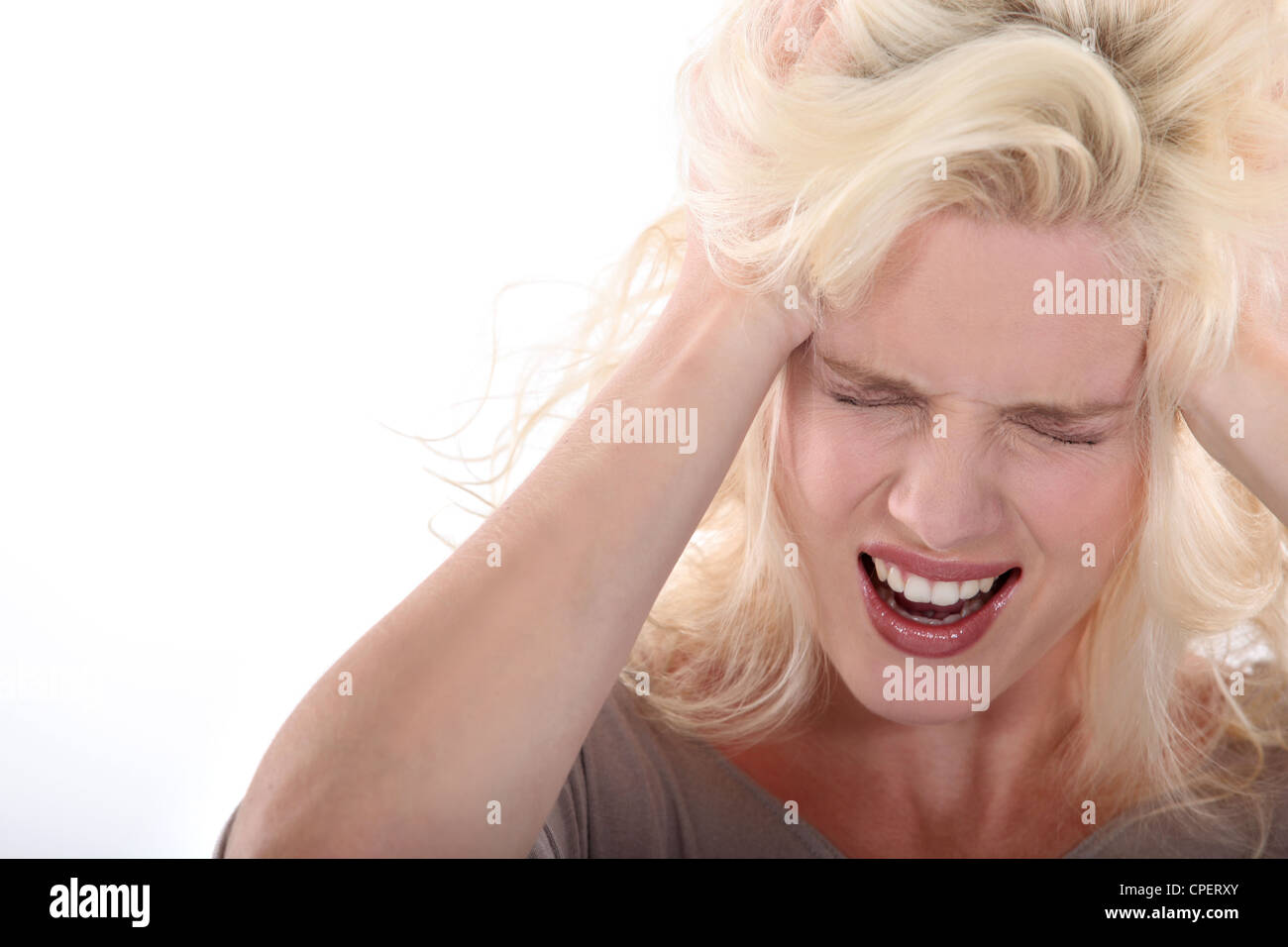 Young blonde pulling her hair Stock Photo