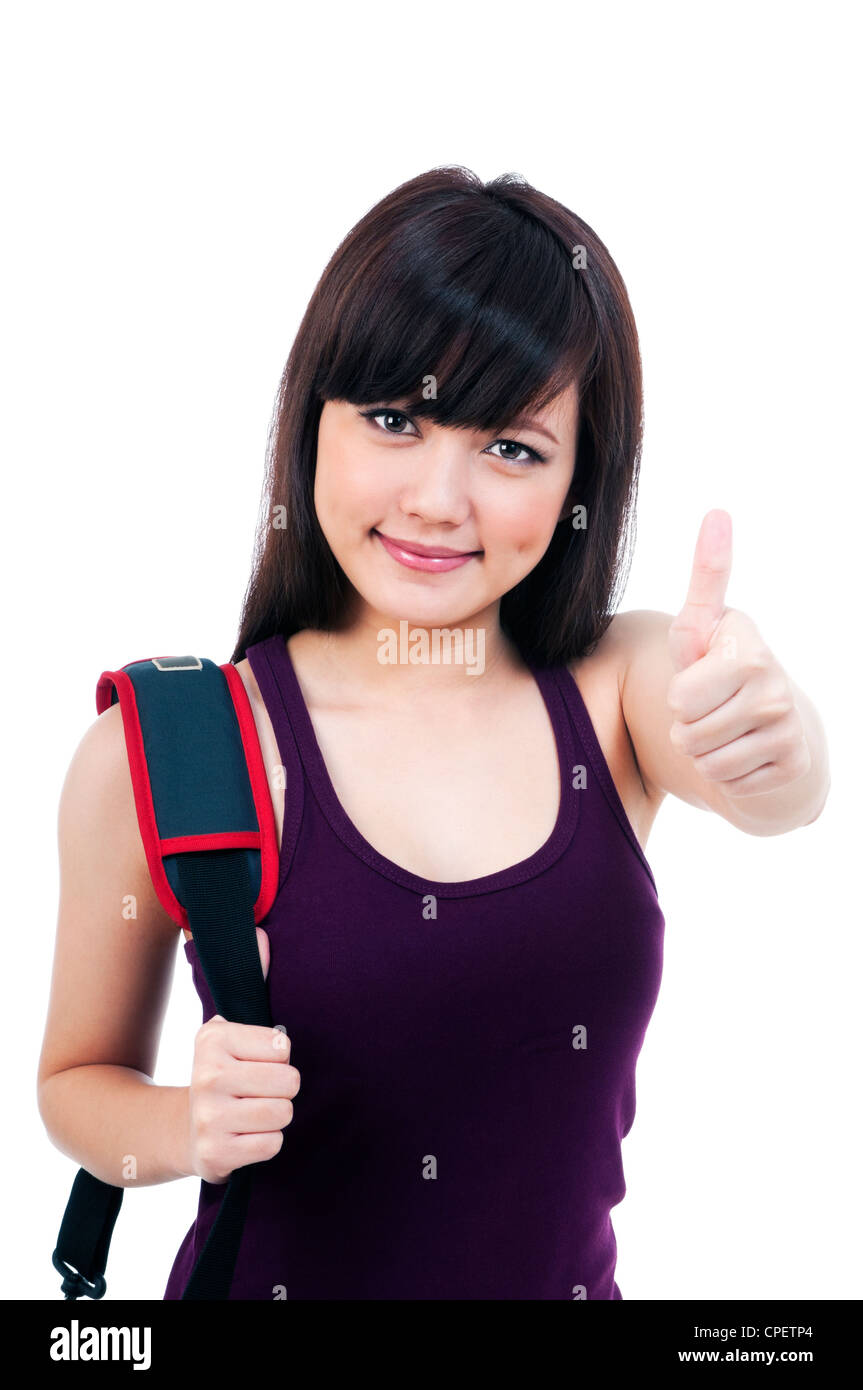 Attractive young female student giving thumb up Stock Photo - Alamy