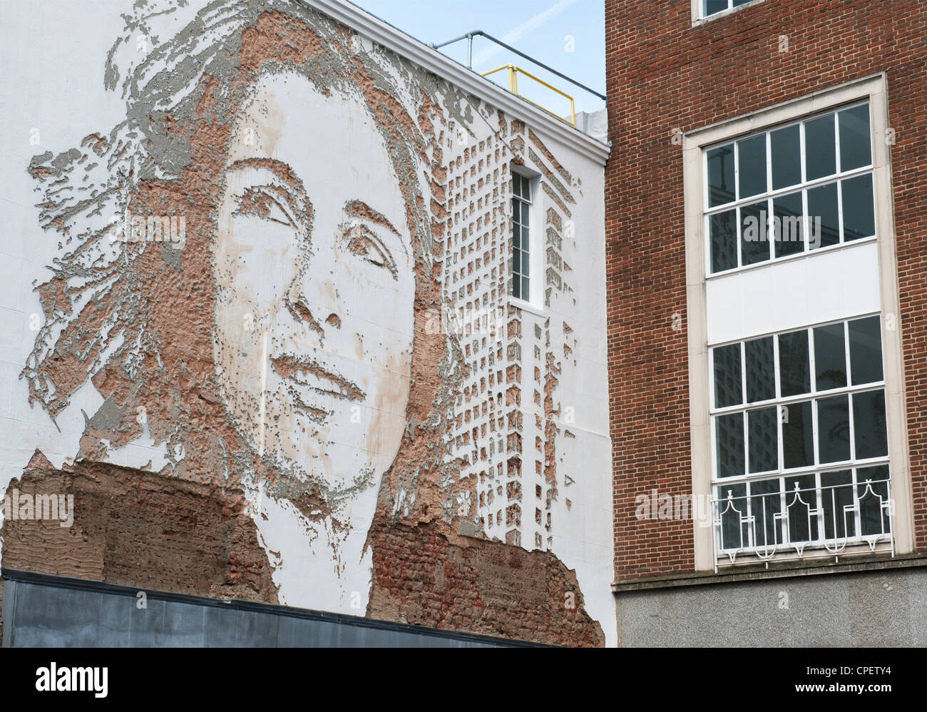 Vhils / Alexandre Farto Street art, Womans head and shoulders wall mural, Exeter, Devon, England Stock Photo