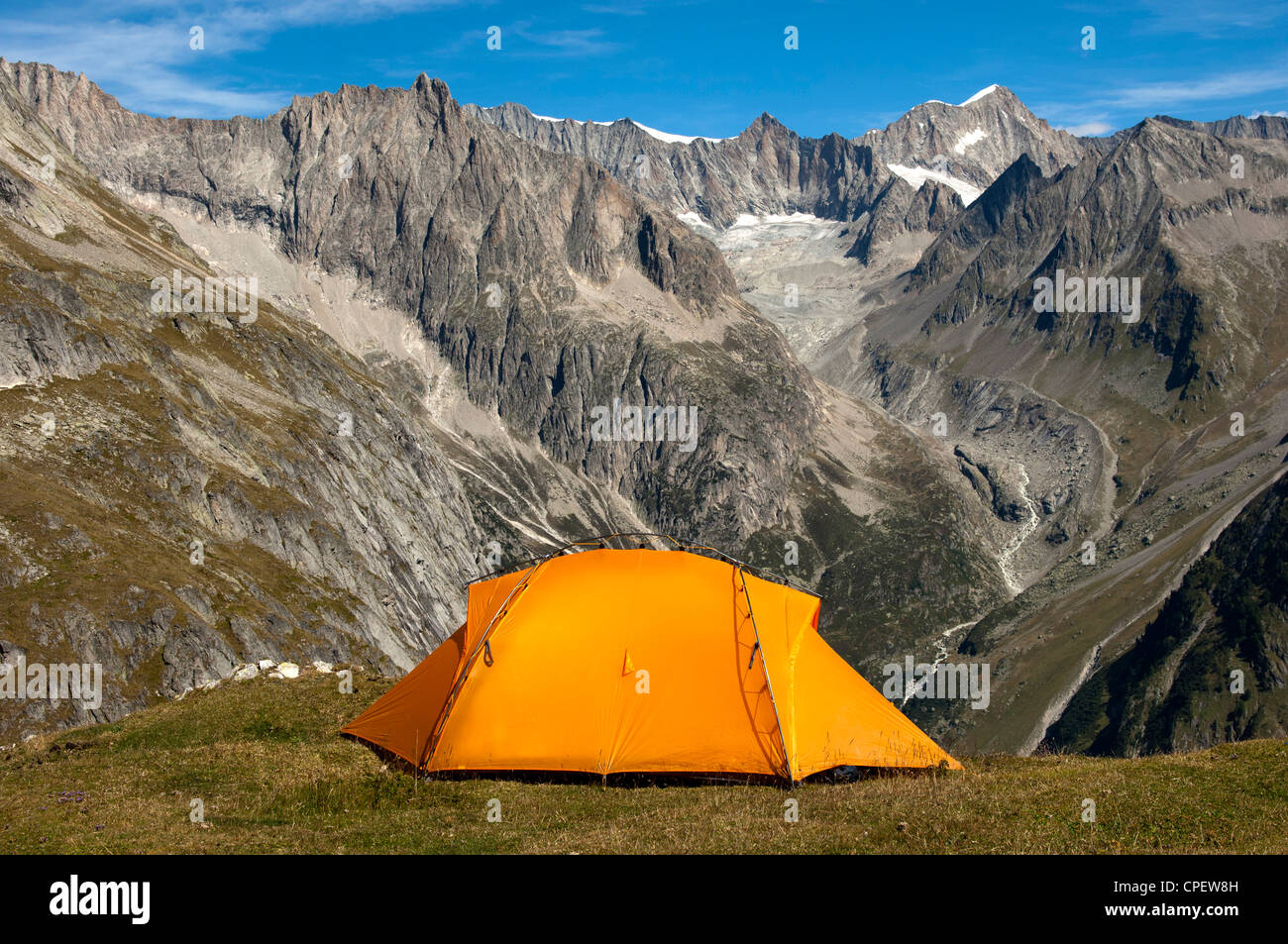 Orange mountain tent above the valley Baltschiedertal, Mt Nesthorn ...