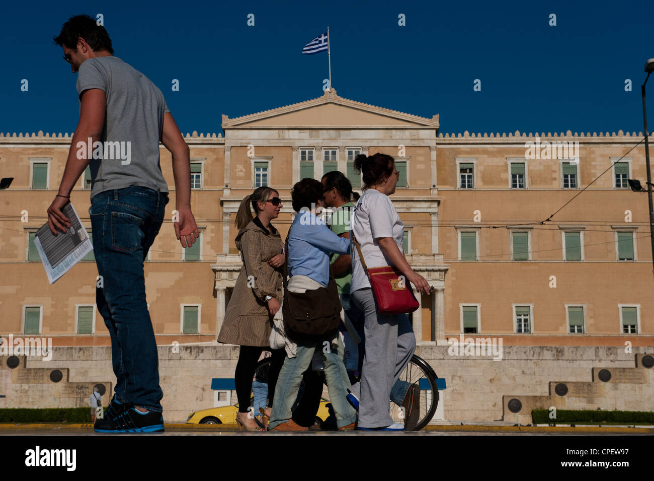 Athenians walking in front of the Greek parliament, Syntagma Sq, Athens, Greece Stock Photo
