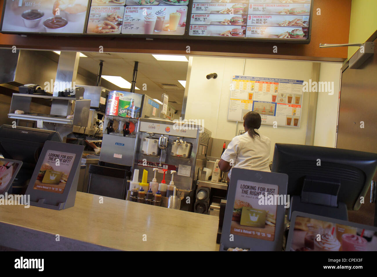 Clermont Florida,Burger King,restaurant restaurants food dining cafe cafes,fast food,service counter,promotions,Black woman female women,employee empl Stock Photo